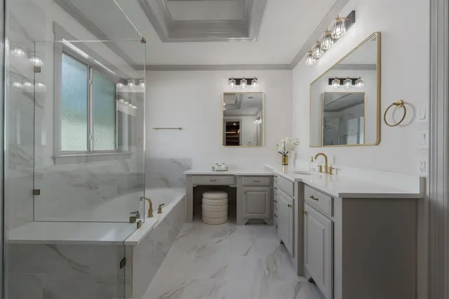 a spacious bathroom with a double vanity sink mirror and bathtub