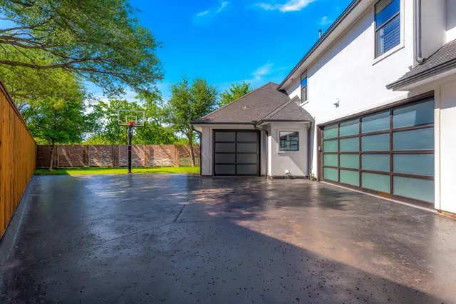 a view of a house with a yard and a garage