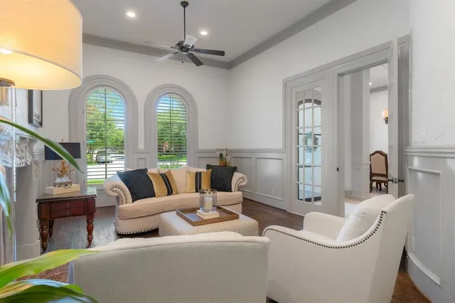 a living room with furniture a fireplace and a large window