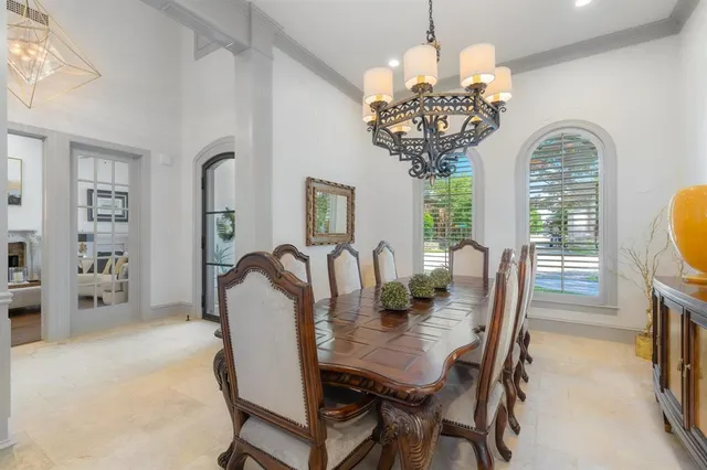 a view of a dining room with furniture and chandelier
