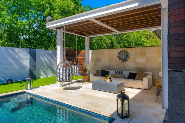 a view of a patio with table and chairs with wooden fence and plants