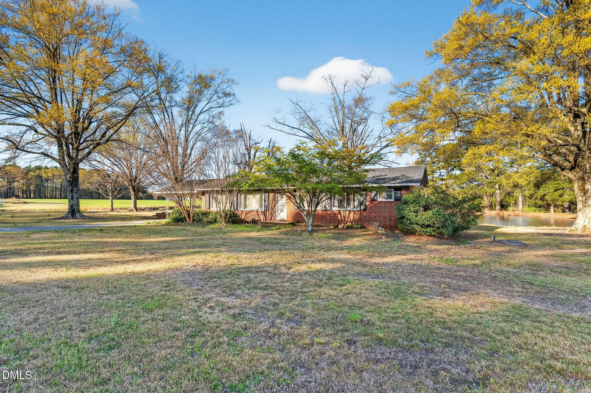 10167 Highway 50 Angier, NC 27501 - Photo 3 of 17 a view of a building with a big yard and large trees