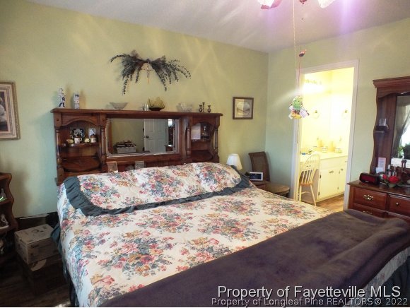 7200 Silver Maple Street Willow Spring, NC 27592 - Photo 3 of 23 a bedroom with a bed and dresser with mirror