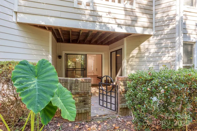 a front view of a house with garden and plants