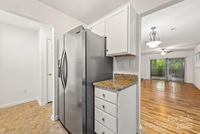 a kitchen with stainless steel appliances granite countertop a refrigerator and a stove