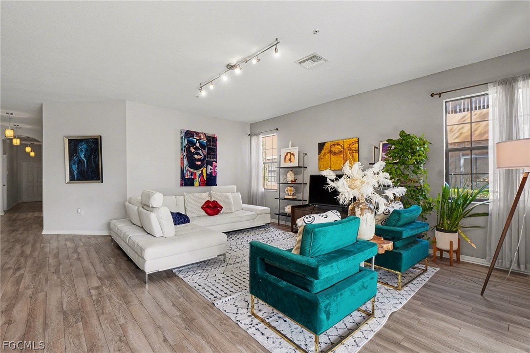 a living room with furniture and wooden floor