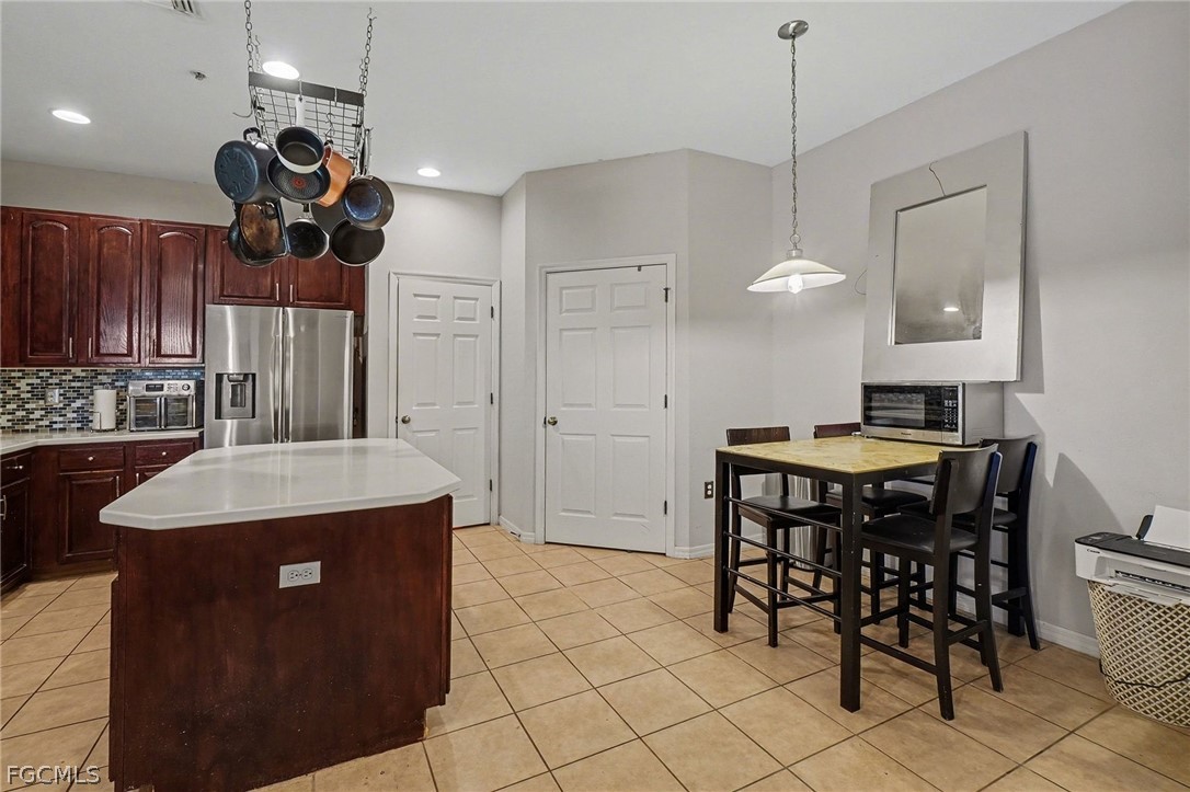 3799 Costa Maya Way, Unit 101 Estero, FL 33928 - Photo 14 of 35 a kitchen with a table and chairs in it