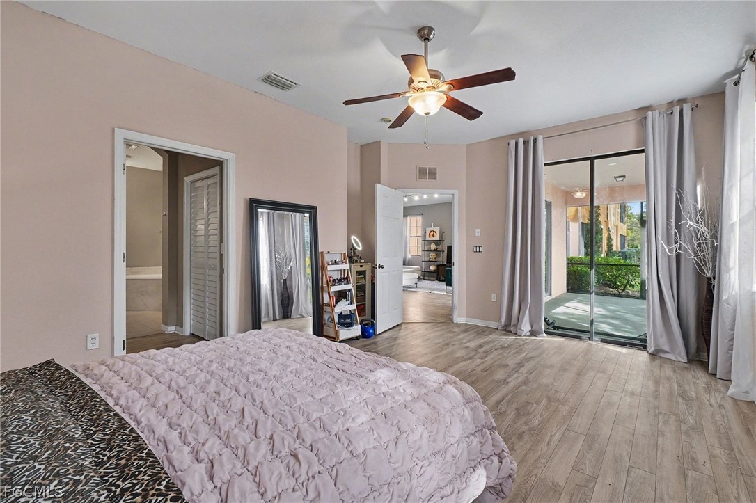 3799 Costa Maya Way, Unit 101 Estero, FL 33928 - Photo 17 of 35 a bedroom with a bed and a large mirror