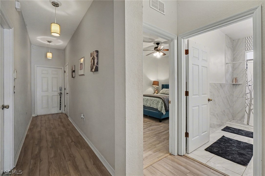 3799 Costa Maya Way, Unit 101 Estero, FL 33928 - Photo 20 of 35 a view of a bedroom from a hallway
