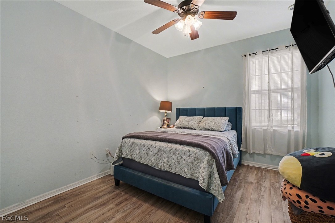 3799 Costa Maya Way, Unit 101 Estero, FL 33928 - Photo 21 of 35 a bedroom with a bed and window
