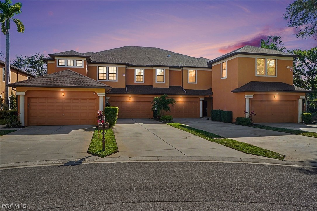 3799 Costa Maya Way, Unit 101 Estero, FL 33928 - Photo 24 of 35 a front view of a house with a yard and garage