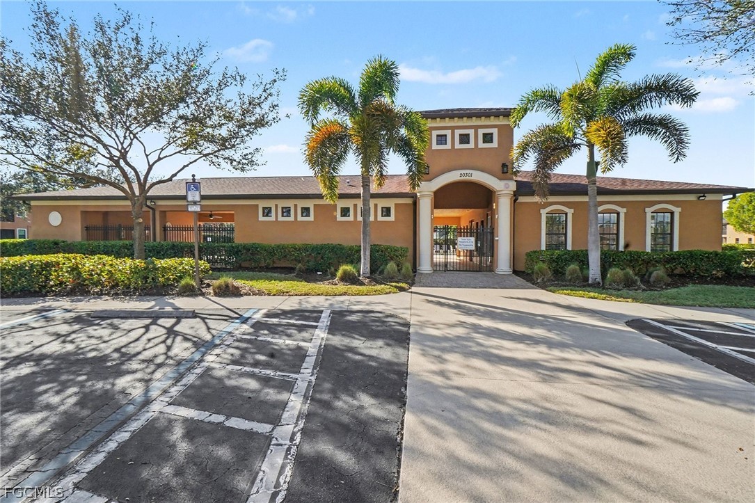3799 Costa Maya Way, Unit 101 Estero, FL 33928 - Photo 25 of 35 a front view of a house with a yard and potted plants