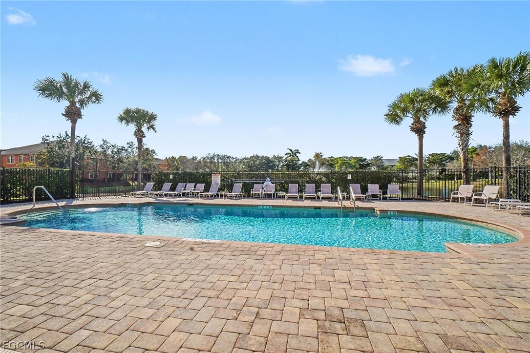 3799 Costa Maya Way, Unit 101 Estero, FL 33928 - Photo 27 of 35 a view of a swimming pool and a chair