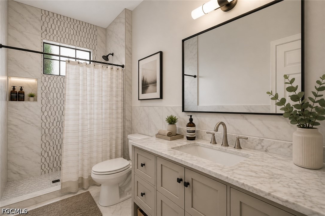 3799 Costa Maya Way, Unit 101 Estero, FL 33928 - Photo 30 of 35 a bathroom with a granite countertop sink a toilet and shower