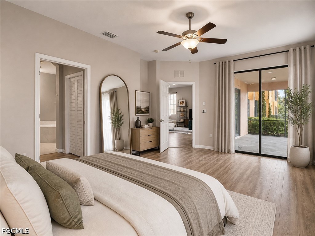 3799 Costa Maya Way, Unit 101 Estero, FL 33928 - Photo 31 of 35 a bedroom with a large bed and a chandelier