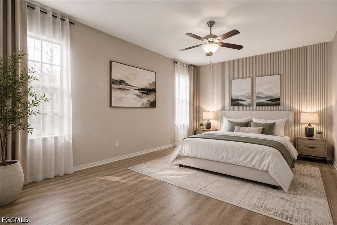 3799 Costa Maya Way, Unit 101 Estero, FL 33928 - Photo 32 of 35 a spacious bedroom with a large bed and a chandelier