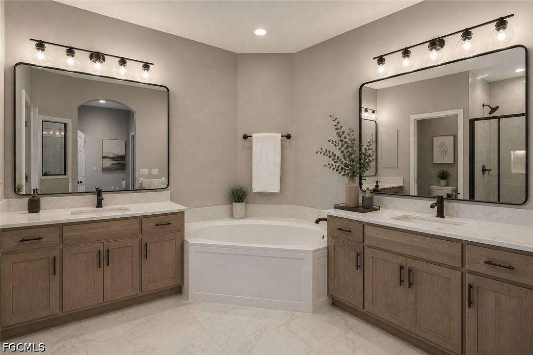 3799 Costa Maya Way, Unit 101 Estero, FL 33928 - Photo 34 of 35 a bathroom with a double vanity sink mirror and bathtub