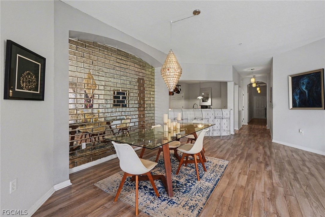 3799 Costa Maya Way, Unit 101 Estero, FL 33928 - Photo 5 of 35 a view of a dining room with furniture and wooden floor