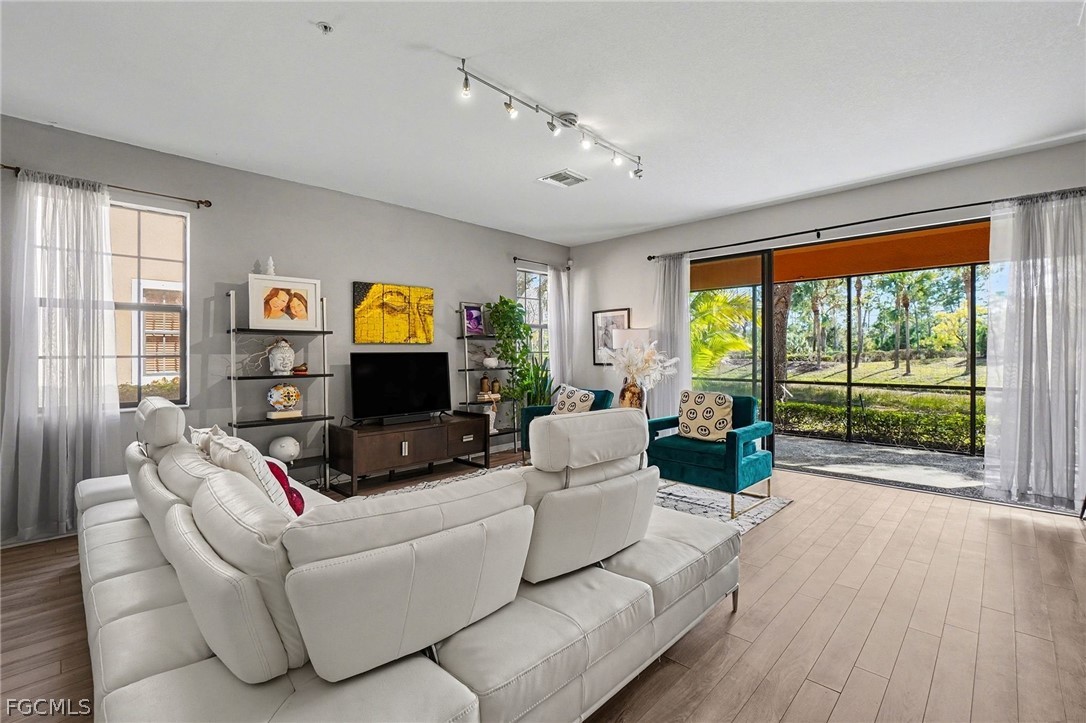3799 Costa Maya Way, Unit 101 Estero, FL 33928 - Photo 7 of 35 a living room with furniture and a flat screen tv