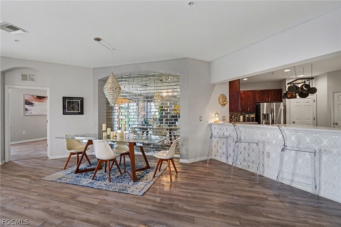 3799 Costa Maya Way, Unit 101 Estero, FL 33928 - Photo 9 of 35 a living room with furniture and wooden floor