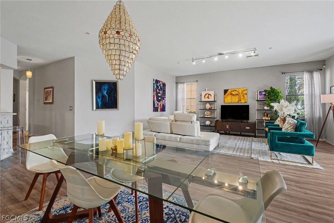 3799 Costa Maya Way, Unit 101 Estero, FL 33928 - Photo 10 of 35 a living room with furniture a flat screen tv and a table