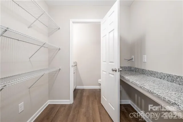 a bathroom with a granite countertop sink and shower