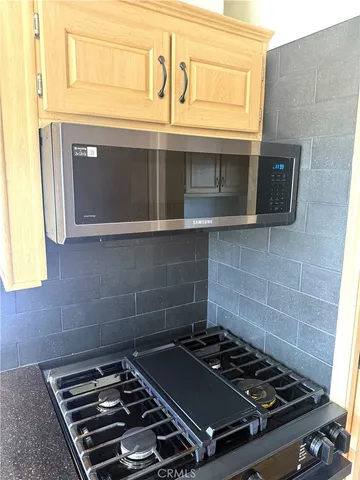 a stove top oven sitting inside of a kitchen