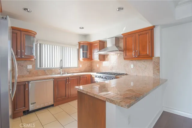 a kitchen with stainless steel appliances granite countertop a sink stove and cabinets
