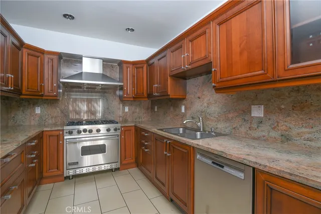 a kitchen with stainless steel appliances granite countertop a sink stove and cabinets