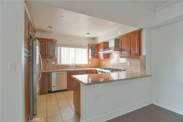a kitchen with granite countertop a sink and a stove