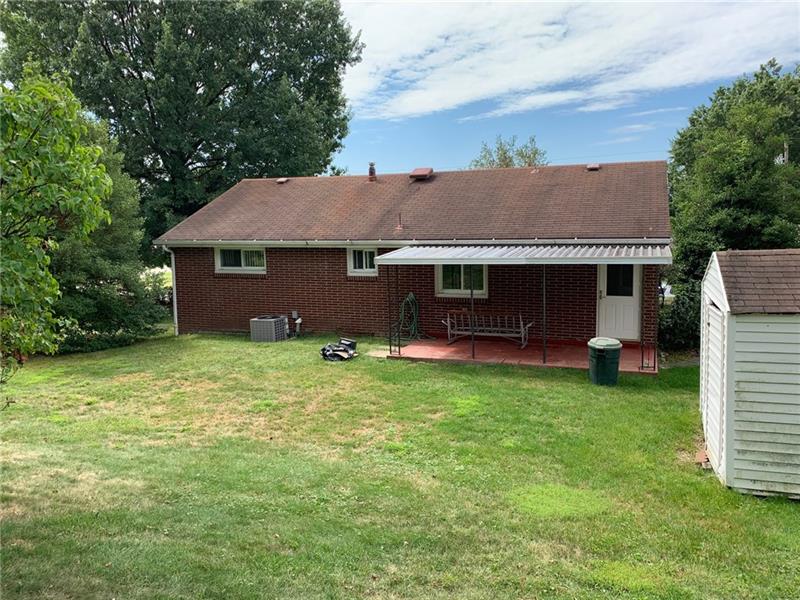 204 Reed Street Lower Burrell, PA 15068 - Photo 2 of 22 Beautiful back yard with covered patio off kitchen. Shed to the right will hold all your landscaping equipment.