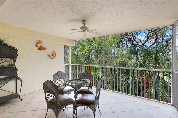 a balcony with table and chairs