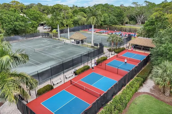a aerial view of a tennis ground and a yard