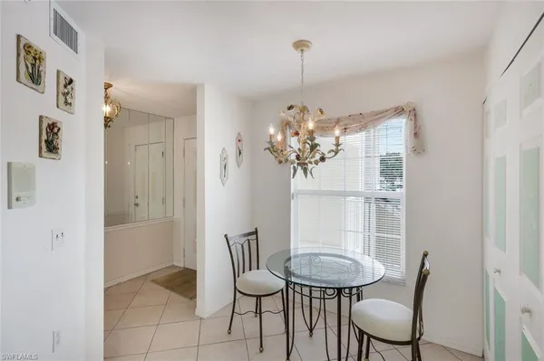 a view of a dining room with furniture and chandelier