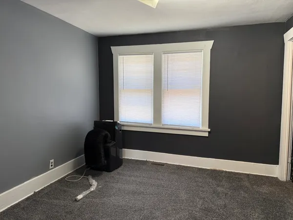 a view of a kitchen with wooden floor and cabinets
