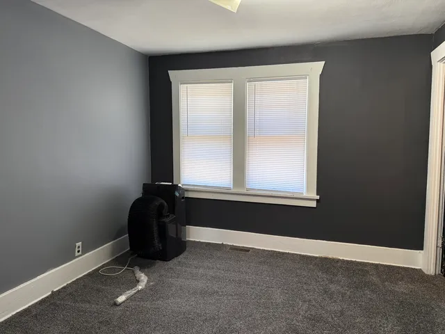 a view of a kitchen with wooden floor and cabinets