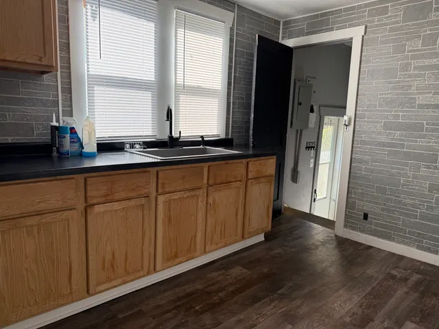 a view of a house with wooden fence