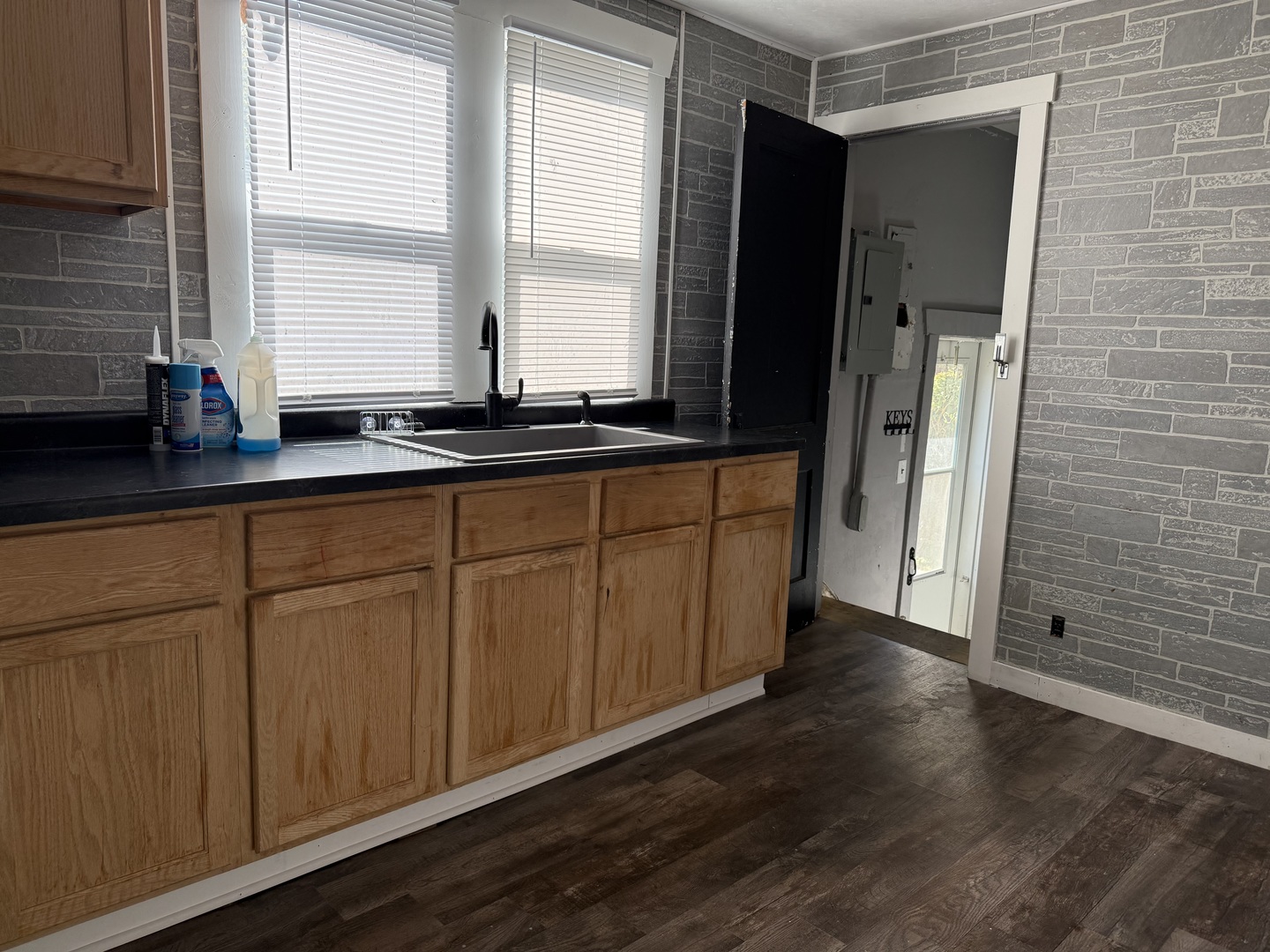 909 West Cushing Street Decatur, IL 62526 - Photo 5 of 6 a view of a kitchen with wooden floor and cabinets