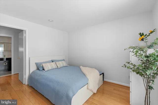 a bedroom with a bed and a potted plant