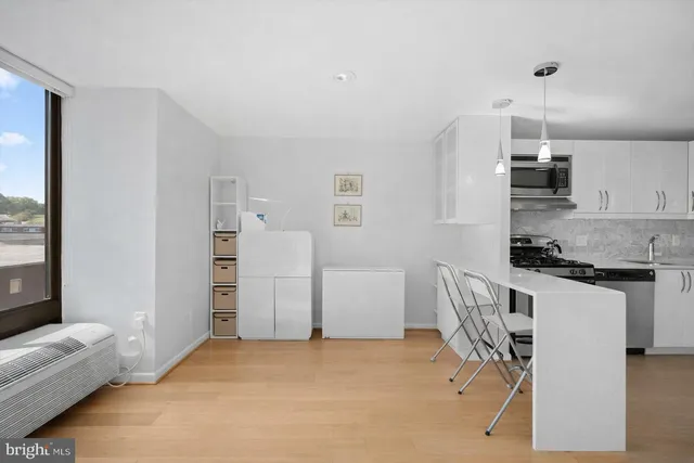 a kitchen with a refrigerator and a stove top oven