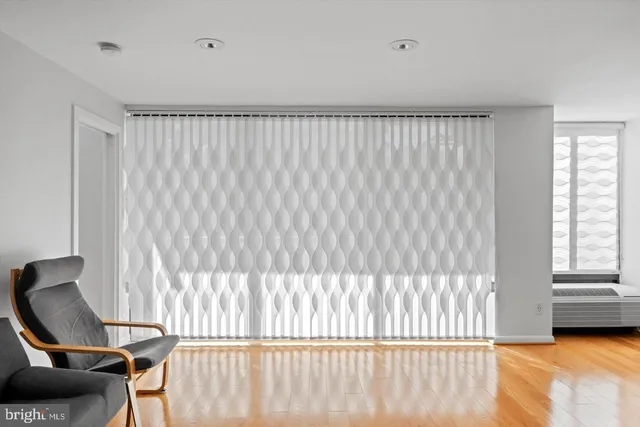 a view of a bedroom with furniture and a window