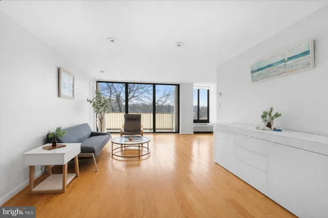 a living room with furniture and large windows