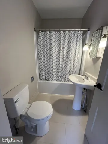 a bathroom with a toilet a sink and bathtub
