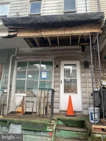 a view of backyard with door and outdoor seating