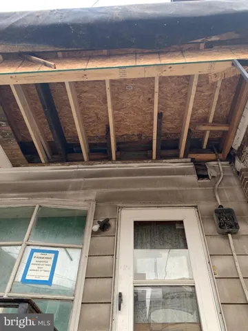 a view of entry way with wooden floor and living room