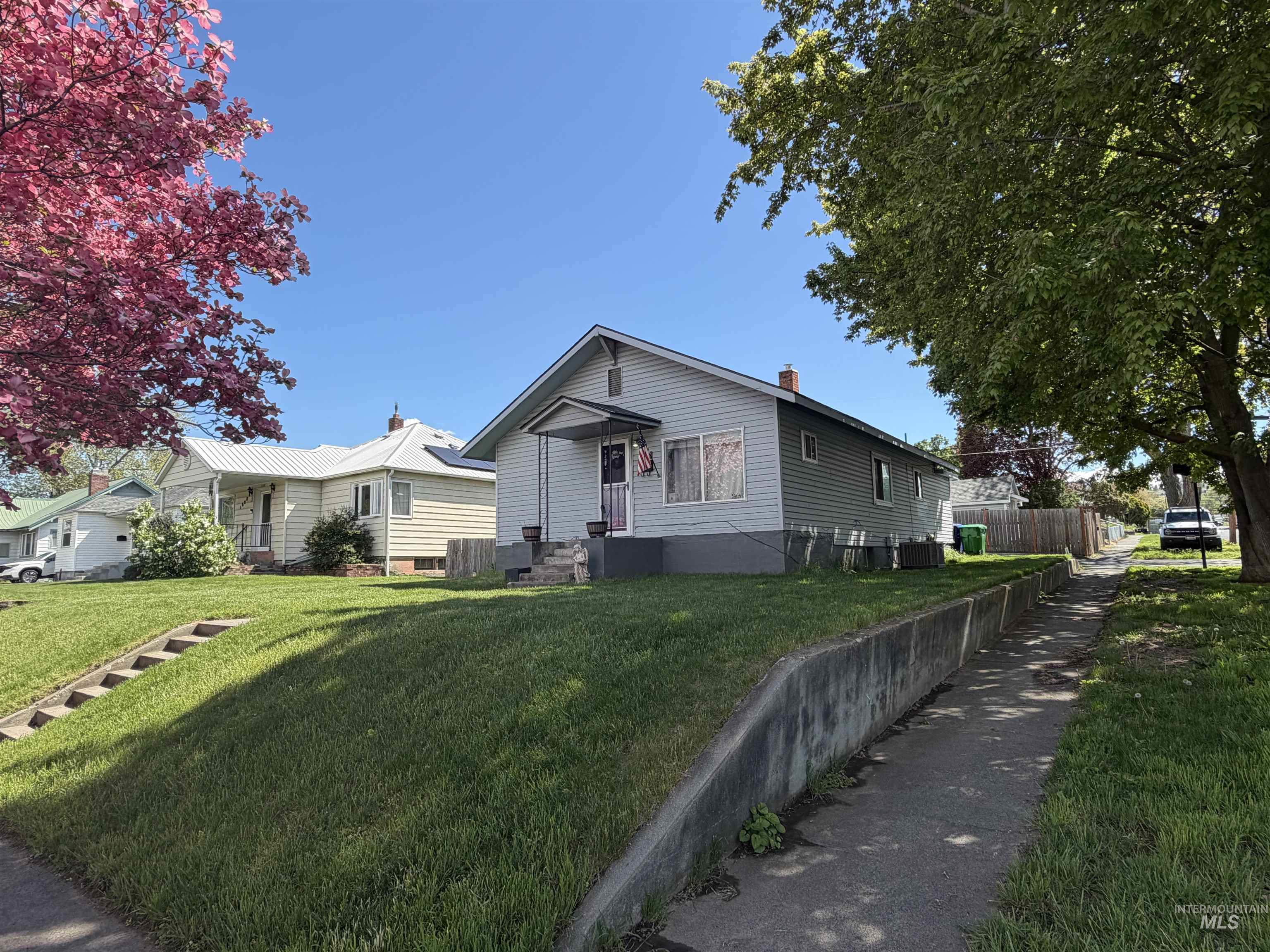 1602 14th Avenue Lewiston, ID 83501 - Photo 1 of 32 Exterior features include light gray siding, a covered front porch, and a well-maintained lawn