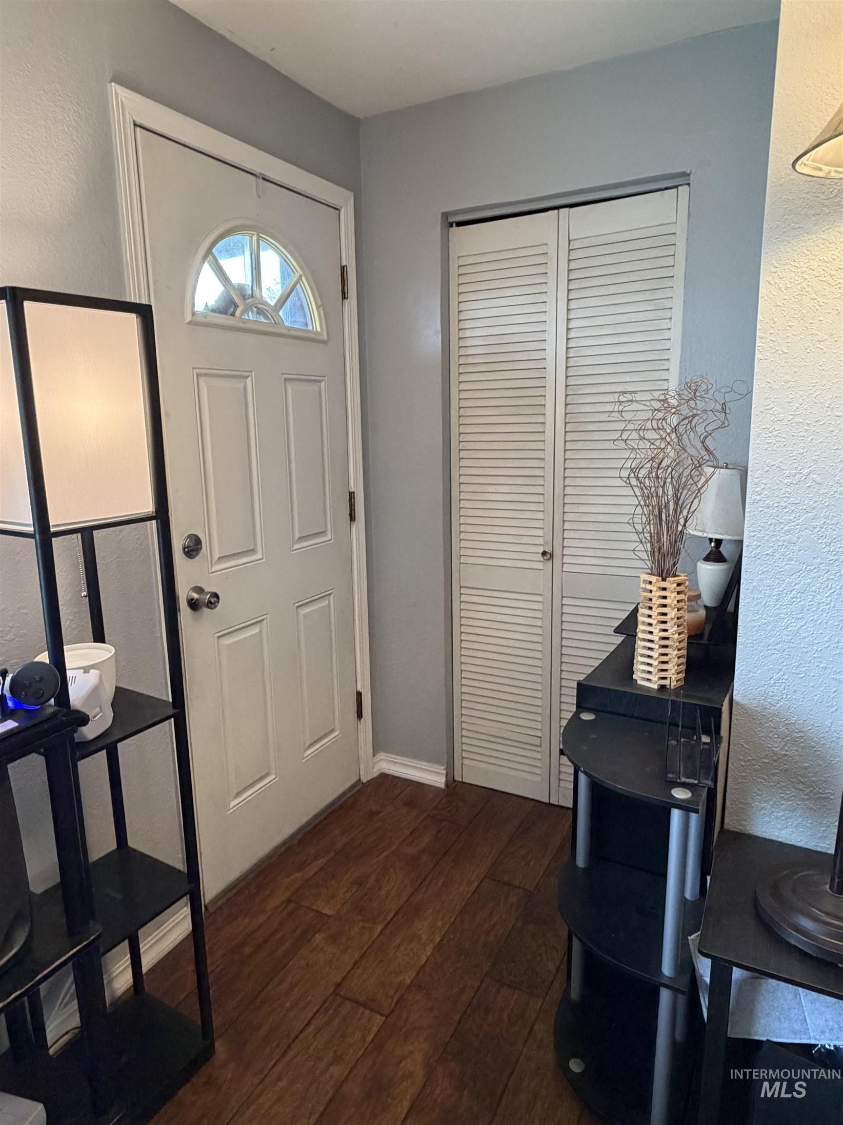 1602 14th Avenue Lewiston, ID 83501 - Photo 12 of 32 Entryway featuring dark wood finished floors and a textured wall