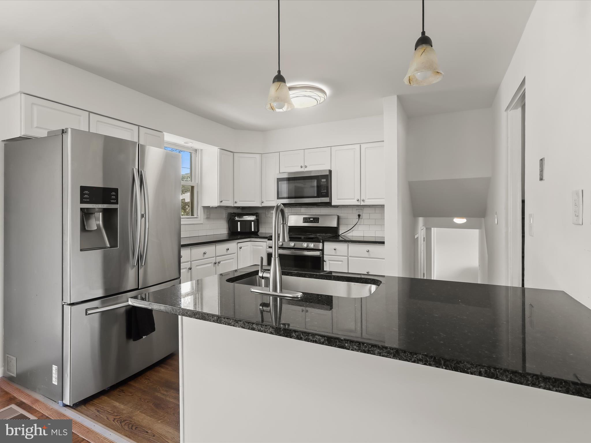 4 Ridgely Road Glen Burnie, MD 21061 - Photo 11 of 47 a kitchen with granite countertop a refrigerator a sink a stove and cabinets
