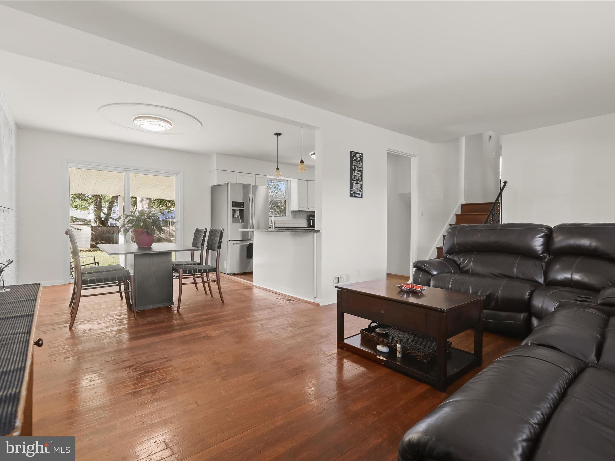 4 Ridgely Road Glen Burnie, MD 21061 - Photo 7 of 47 a living room with furniture and a dining table with kitchen view