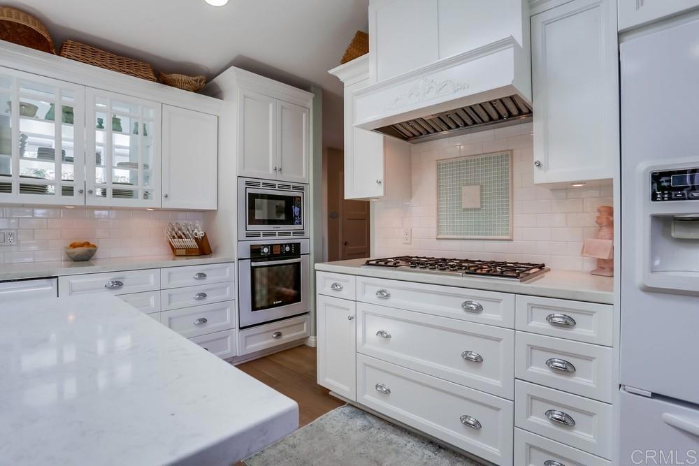653 Marsolan Avenue Solana Beach, CA 92075 - Photo 16 of 29 a kitchen with white cabinets and appliances